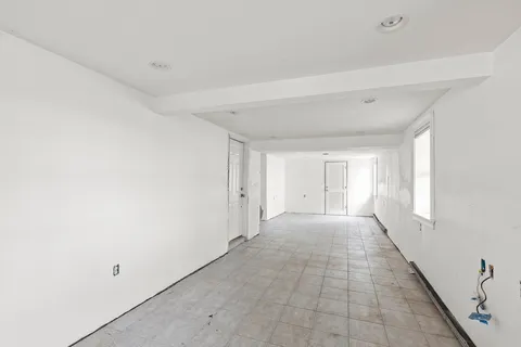 a view of a livingroom with an empty space and a window