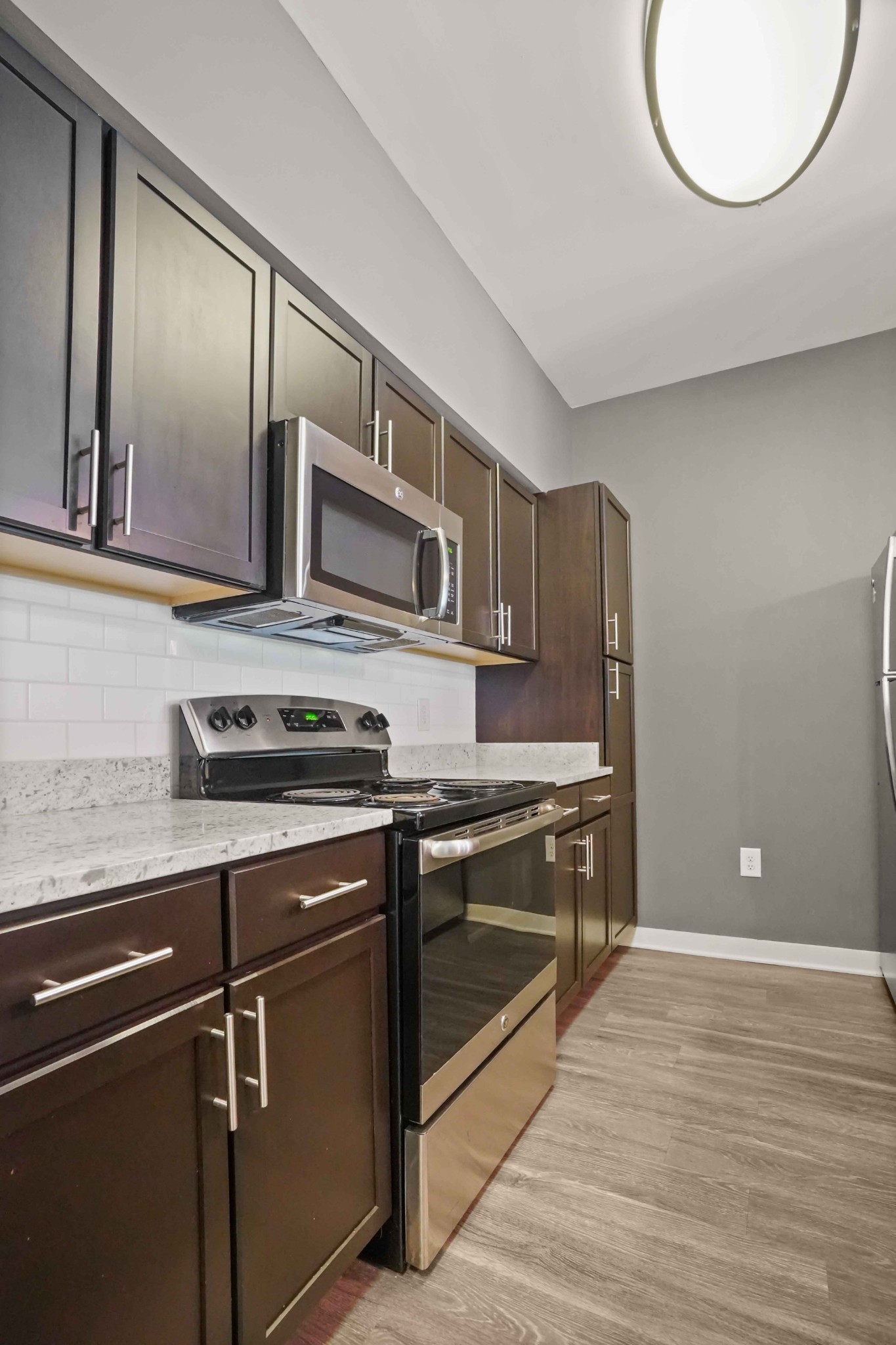 414 Rosedale Avenue, Unit 308 Nashville, TN 37211 - Photo 11 of 26 a kitchen with stainless steel appliances granite countertop a stove and a microwave