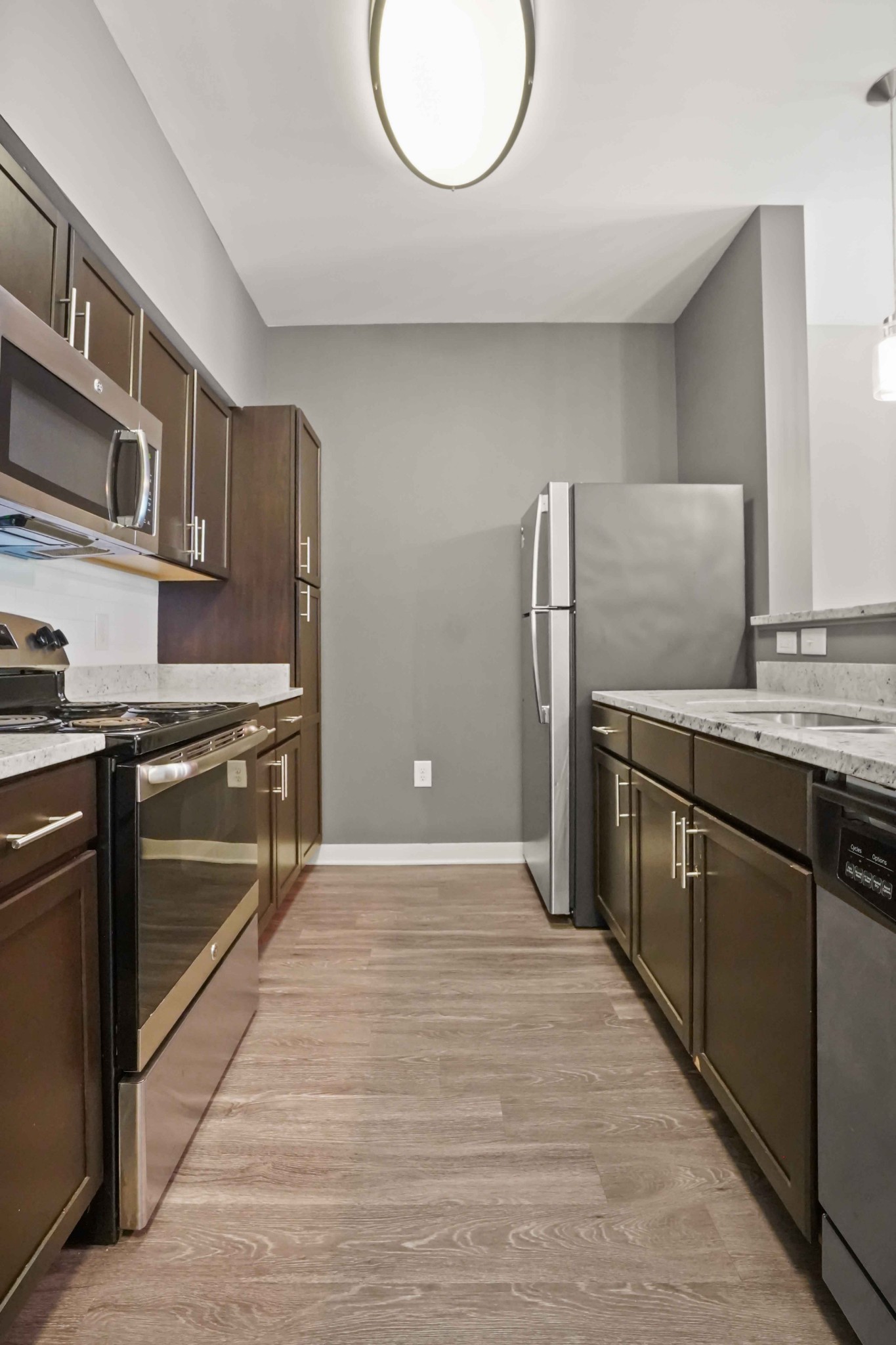 414 Rosedale Avenue, Unit 308 Nashville, TN 37211 - Photo 12 of 26 a kitchen with stainless steel appliances granite countertop a refrigerator and a stove top oven