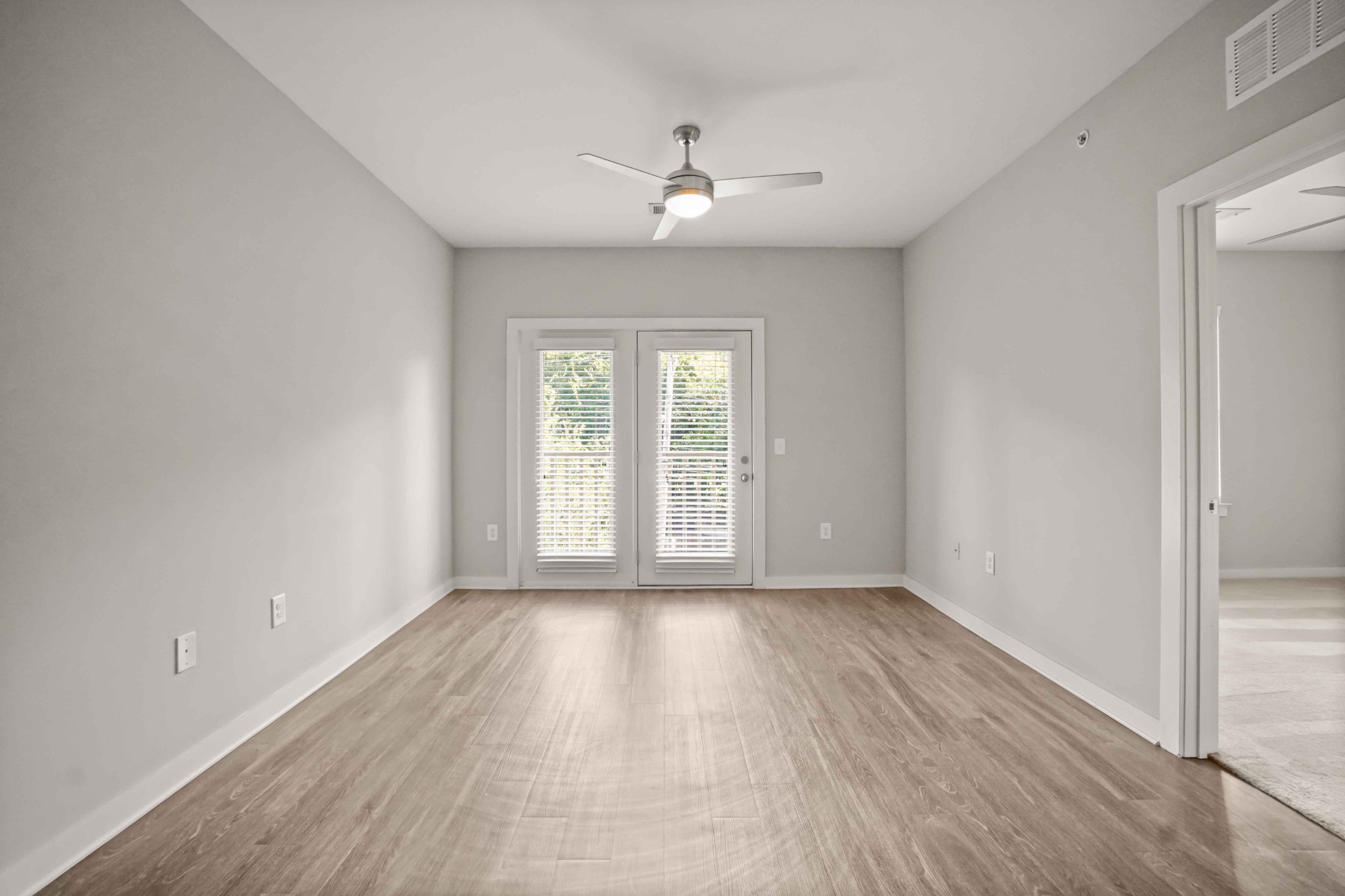 414 Rosedale Avenue, Unit 308 Nashville, TN 37211 - Photo 2 of 26 a view of an empty room with wooden floor and a window