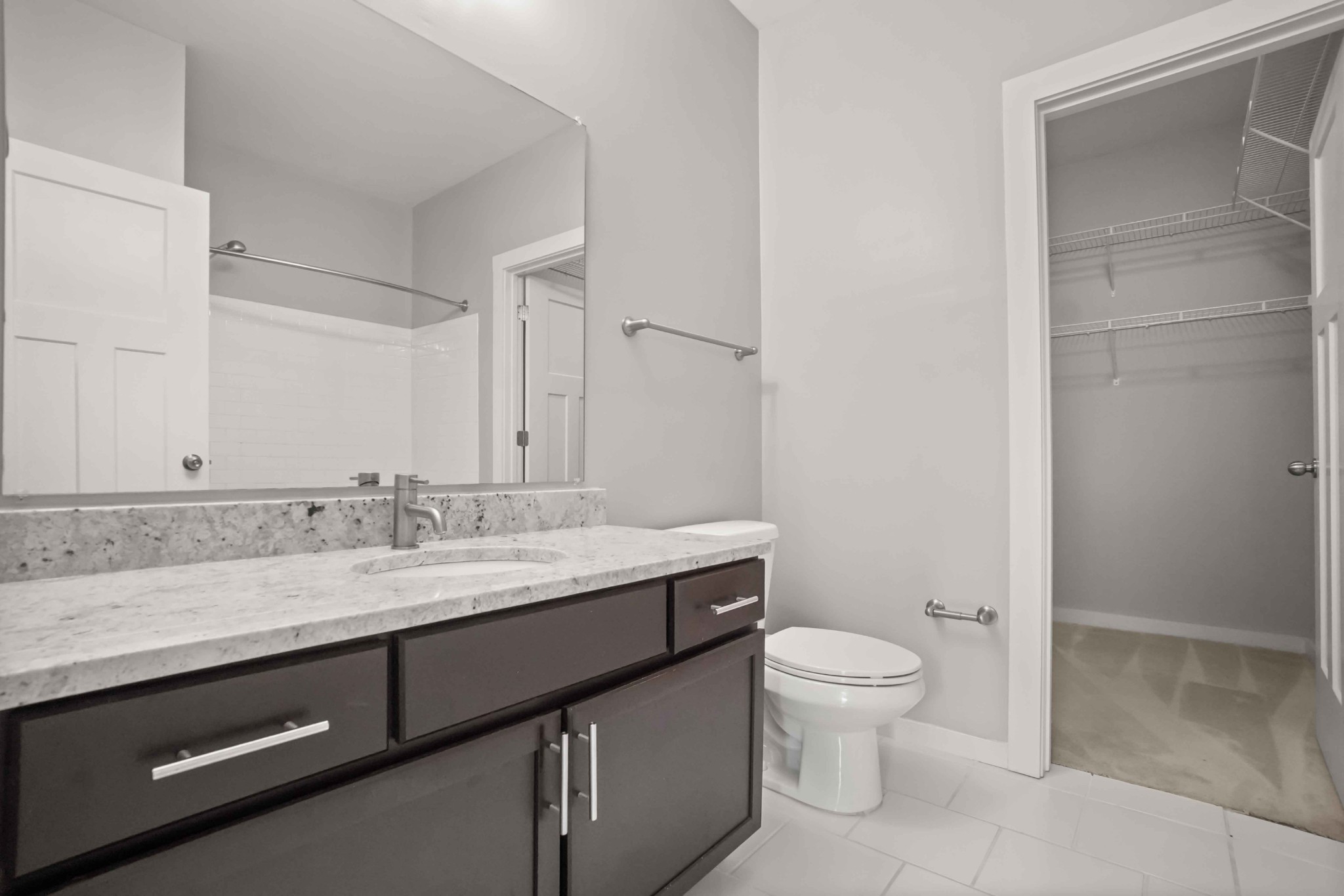 414 Rosedale Avenue, Unit 308 Nashville, TN 37211 - Photo 23 of 26 a bathroom with a granite countertop sink a toilet and a mirror