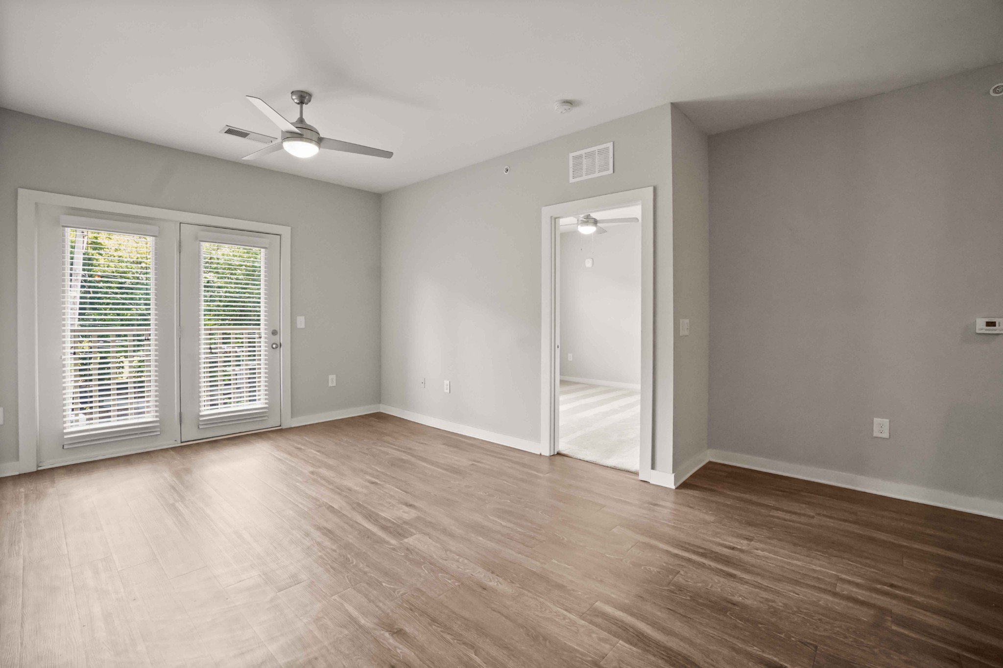 414 Rosedale Avenue, Unit 308 Nashville, TN 37211 - Photo 4 of 26 a view of an empty room with wooden floor and a window
