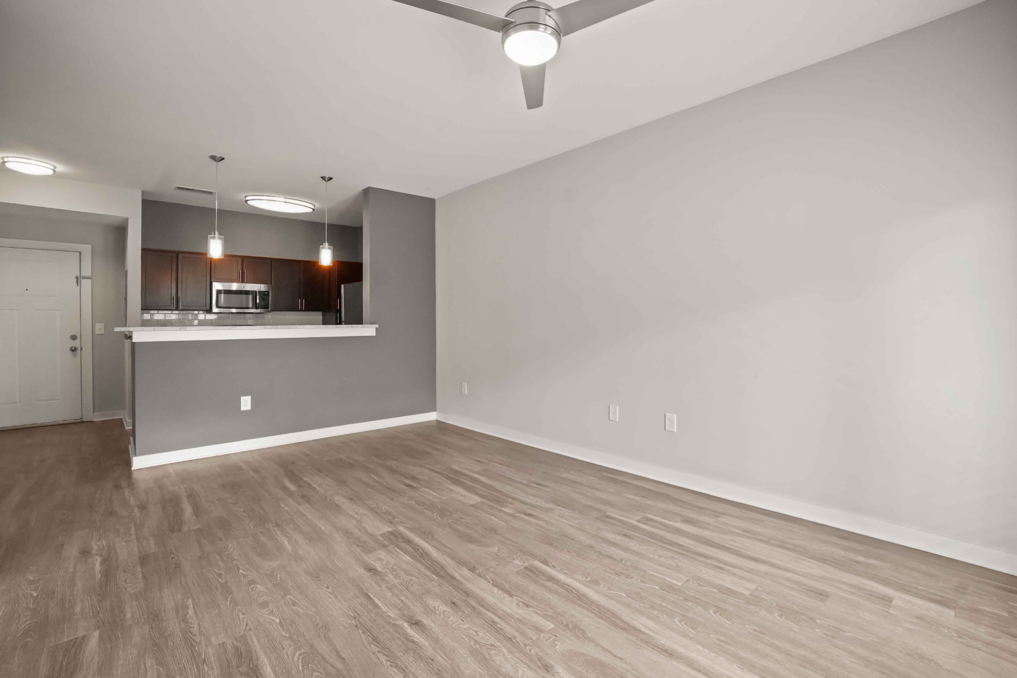 414 Rosedale Avenue, Unit 308 Nashville, TN 37211 - Photo 5 of 26 wooden floor in an empty room with a kitchen