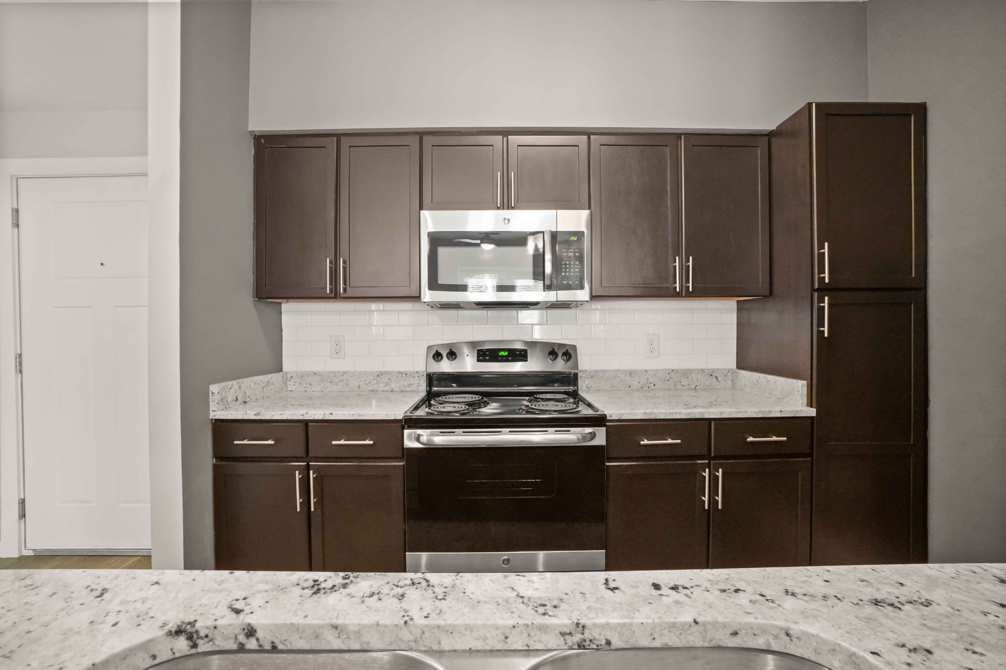 414 Rosedale Avenue, Unit 308 Nashville, TN 37211 - Photo 8 of 26 a kitchen with granite countertop a stove and a refrigerator