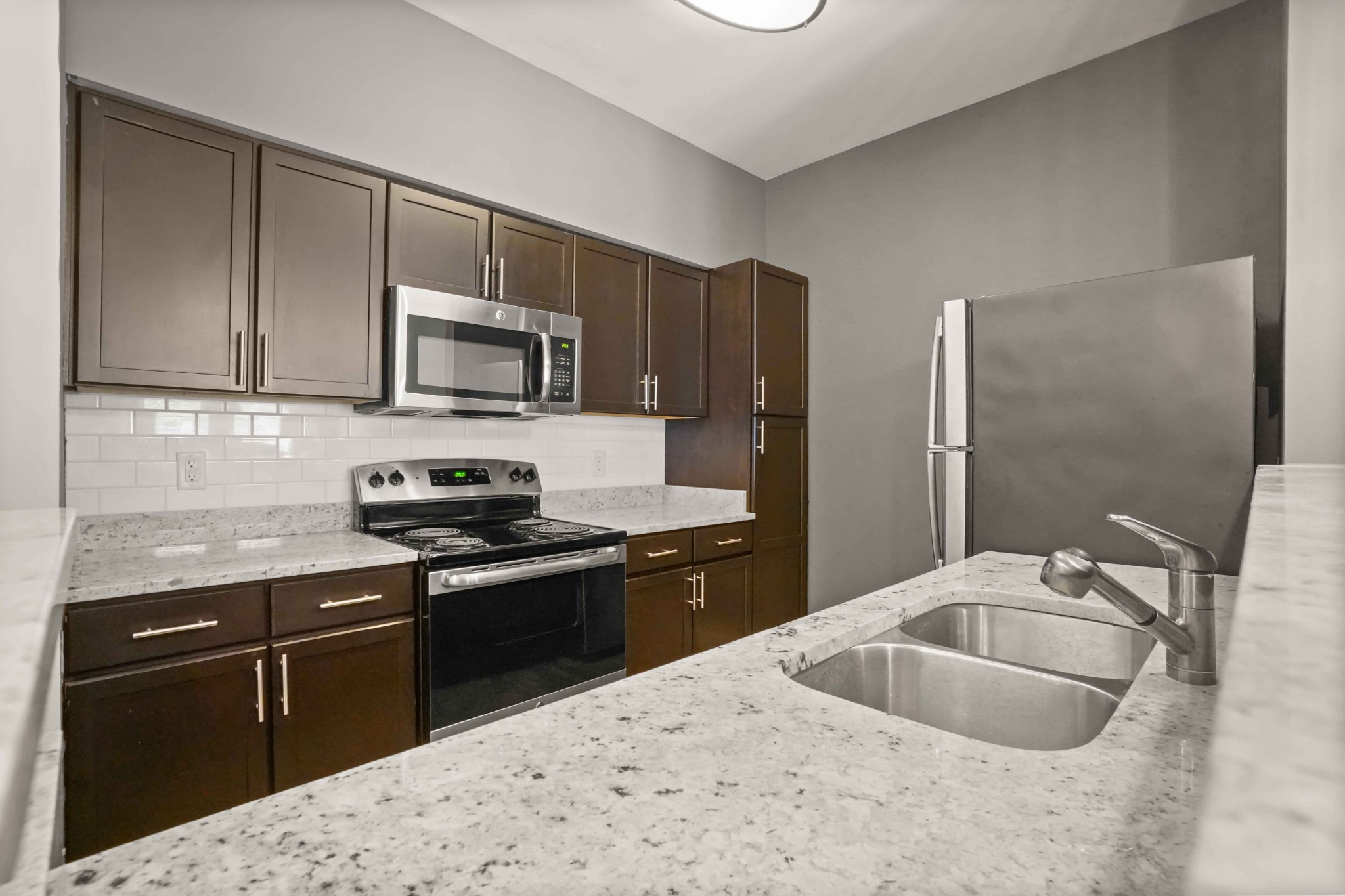 414 Rosedale Avenue, Unit 308 Nashville, TN 37211 - Photo 9 of 26 a kitchen with stainless steel appliances granite countertop a sink stove and refrigerator
