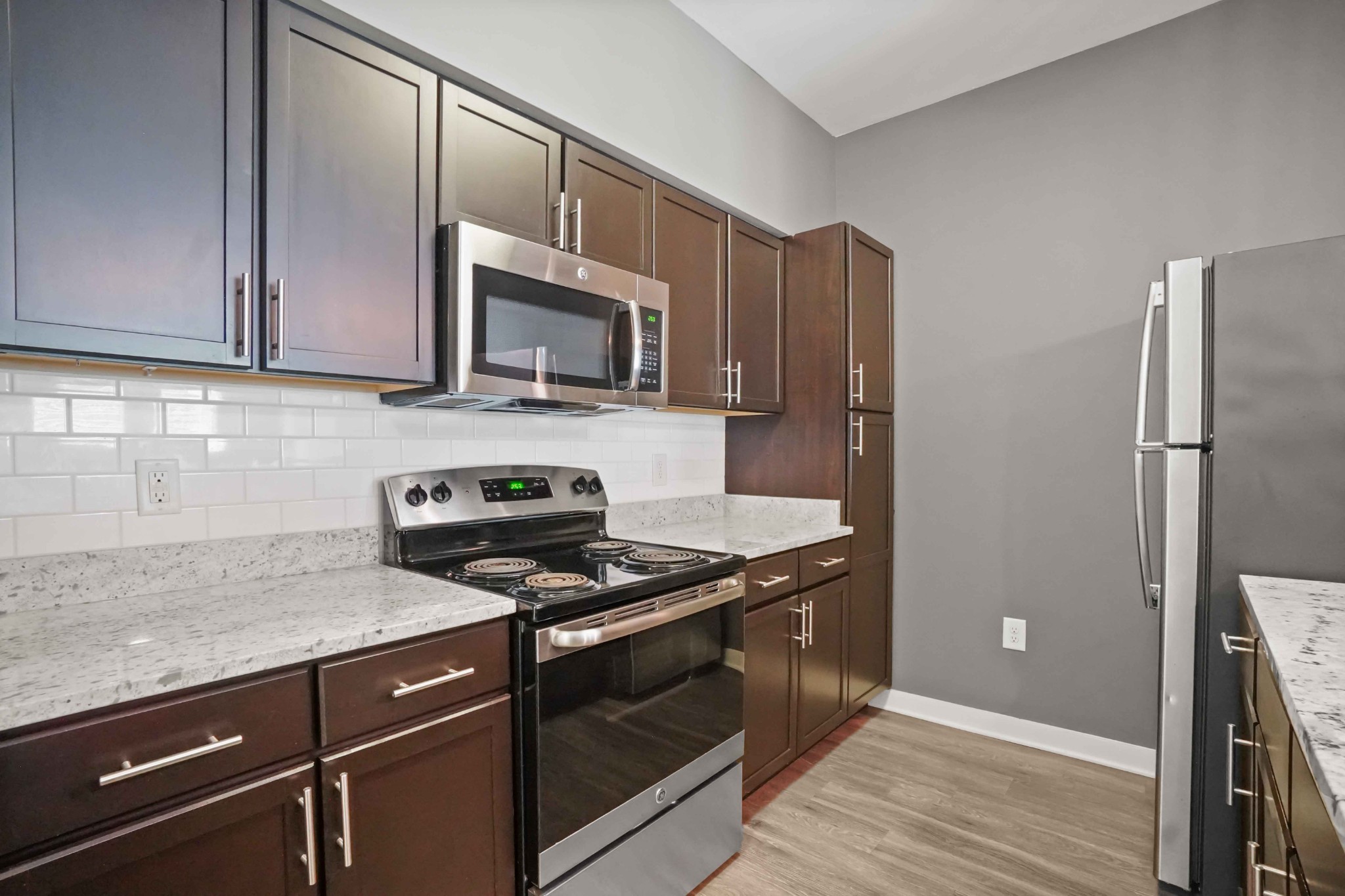 414 Rosedale Avenue, Unit 308 Nashville, TN 37211 - Photo 10 of 26 a kitchen with granite countertop a refrigerator stove and microwave