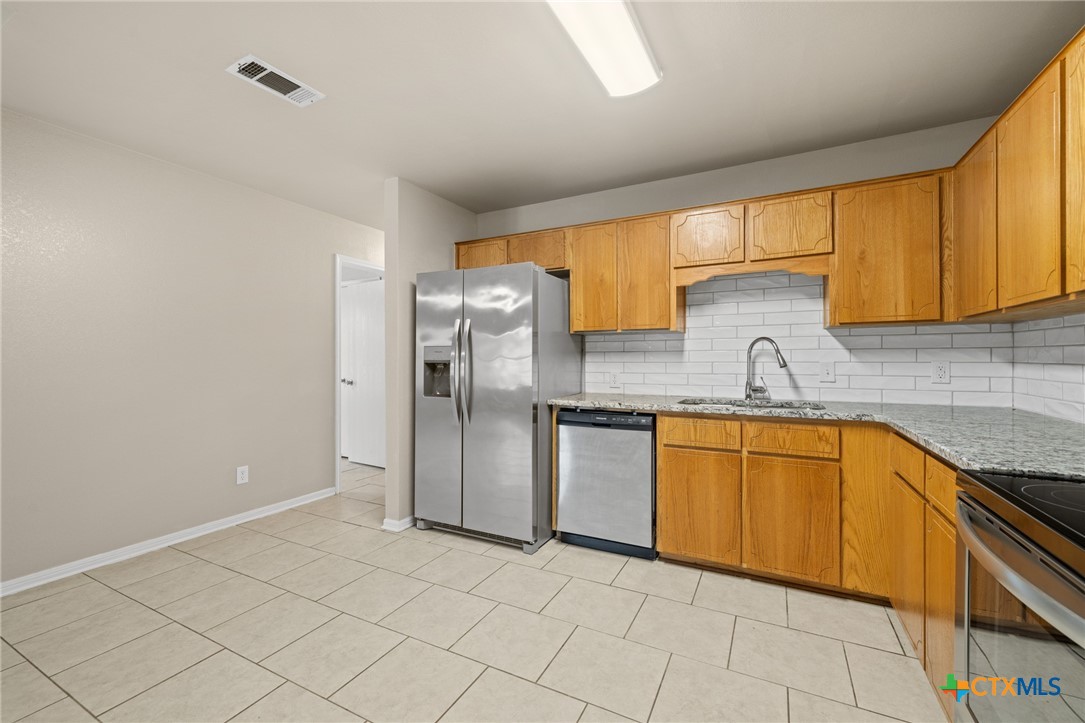 1803 Aztec Trace Harker Heights, TX 76548 - Photo 13 of 42 a kitchen with granite countertop a sink stainless steel appliances and cabinets