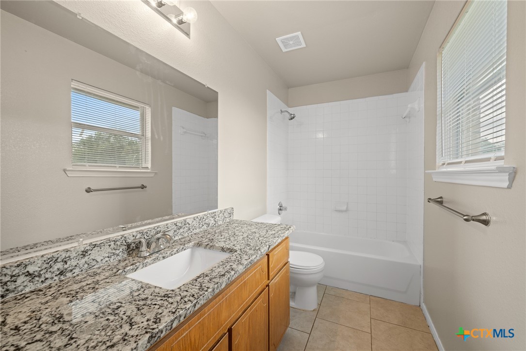 1803 Aztec Trace Harker Heights, TX 76548 - Photo 17 of 42 a bathroom with a granite countertop sink and a mirror