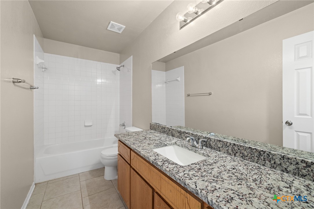 1803 Aztec Trace Harker Heights, TX 76548 - Photo 20 of 42 a bathroom with a granite countertop sink and a mirror