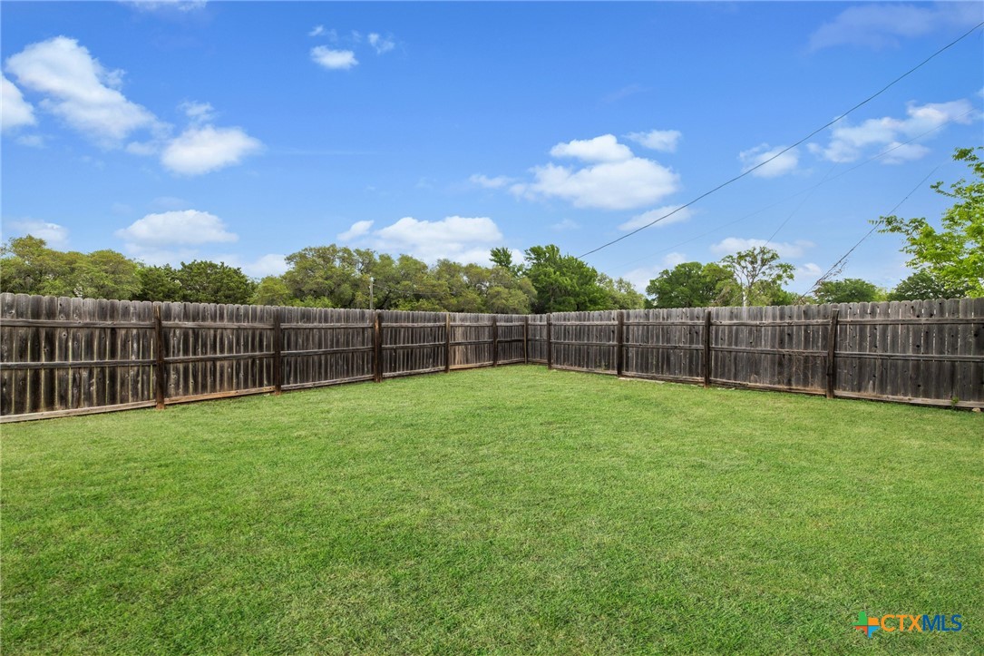1803 Aztec Trace Harker Heights, TX 76548 - Photo 24 of 42 a view of a yard with a fence and trees