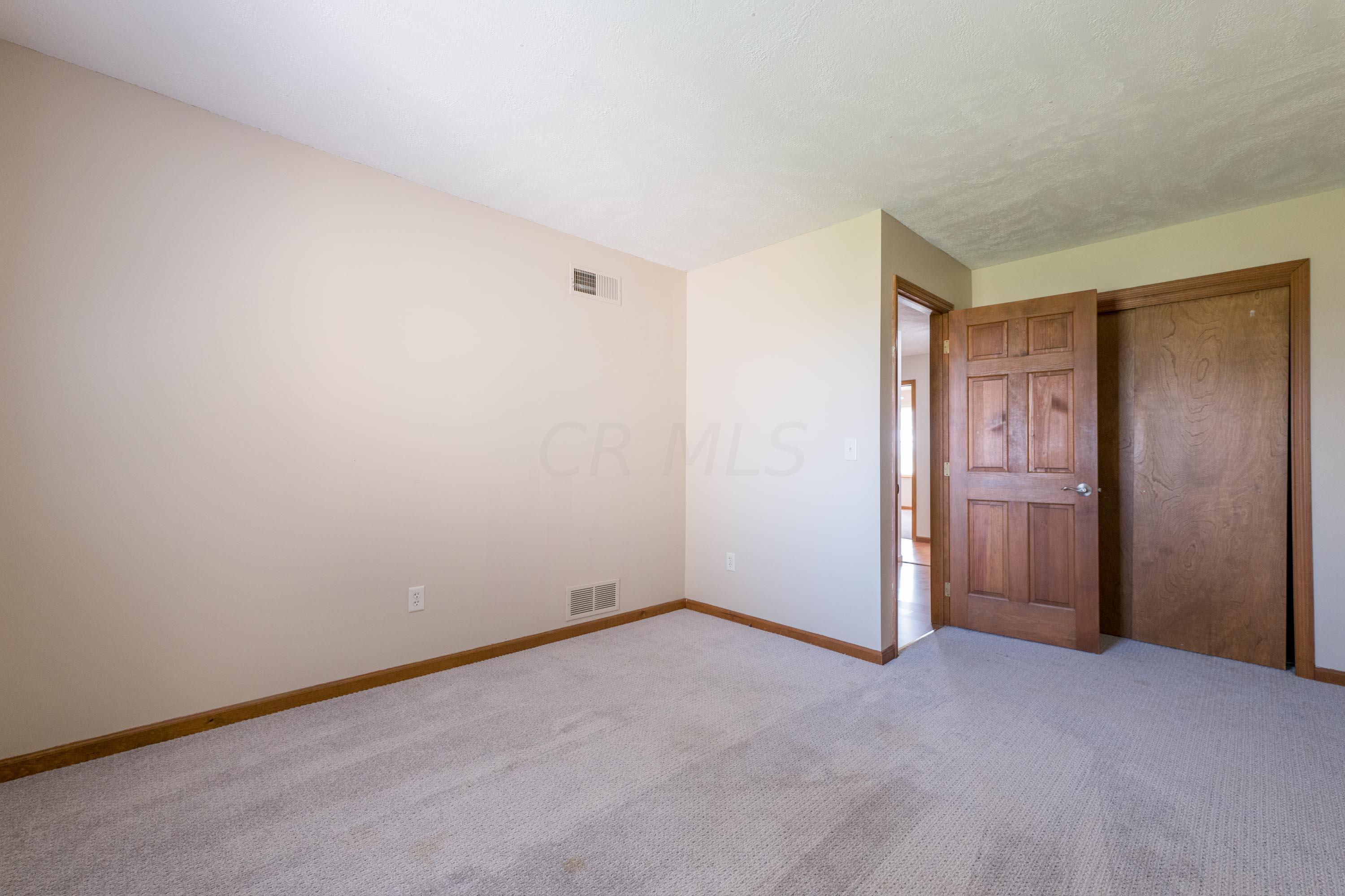 8378 Opossum Run Road London, OH 43140 - Photo 45 of 74 solid wood door, neutral clean carpet