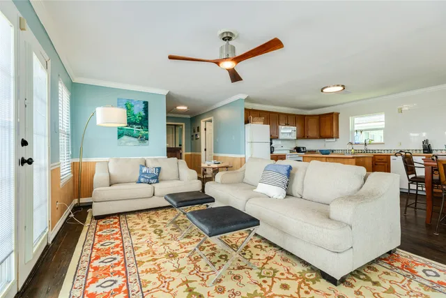 a living room with furniture and view of kitchen