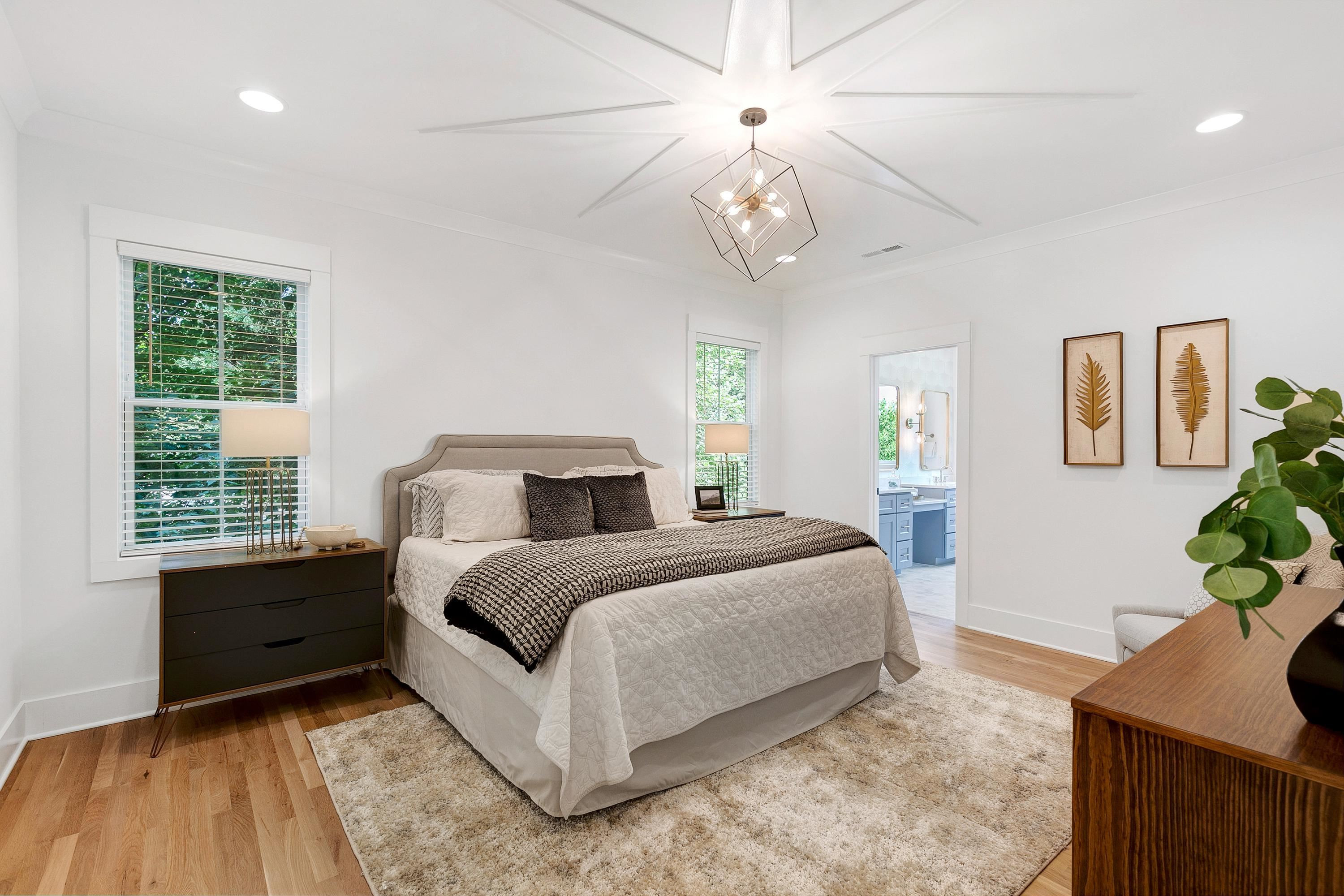 118 Summit Avenue Raleigh, NC 27603 - Photo 12 of 30 a spacious bedroom with a bed and a table in it