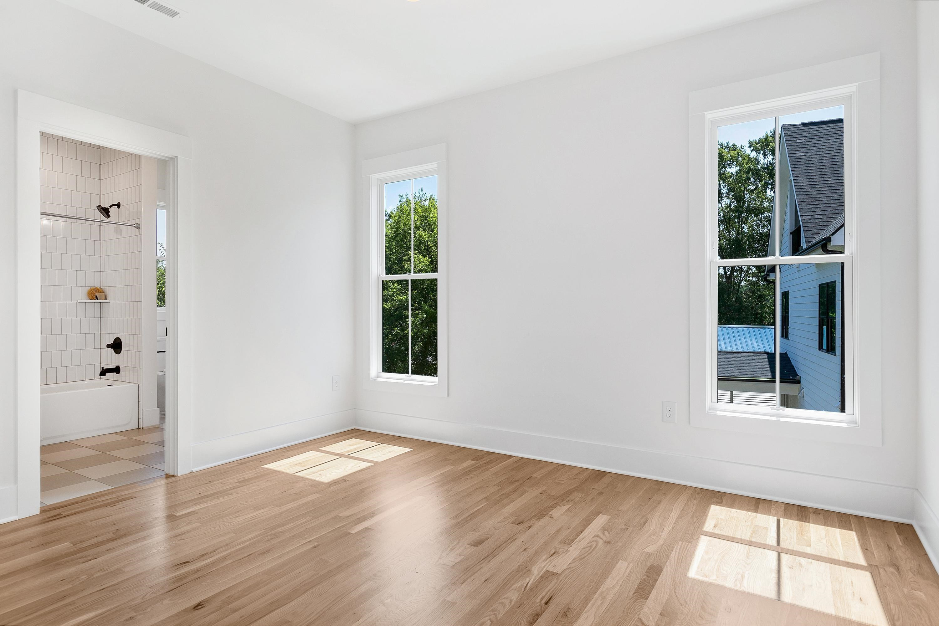 118 Summit Avenue Raleigh, NC 27603 - Photo 18 of 30 a view of an empty room with wooden floor and a window