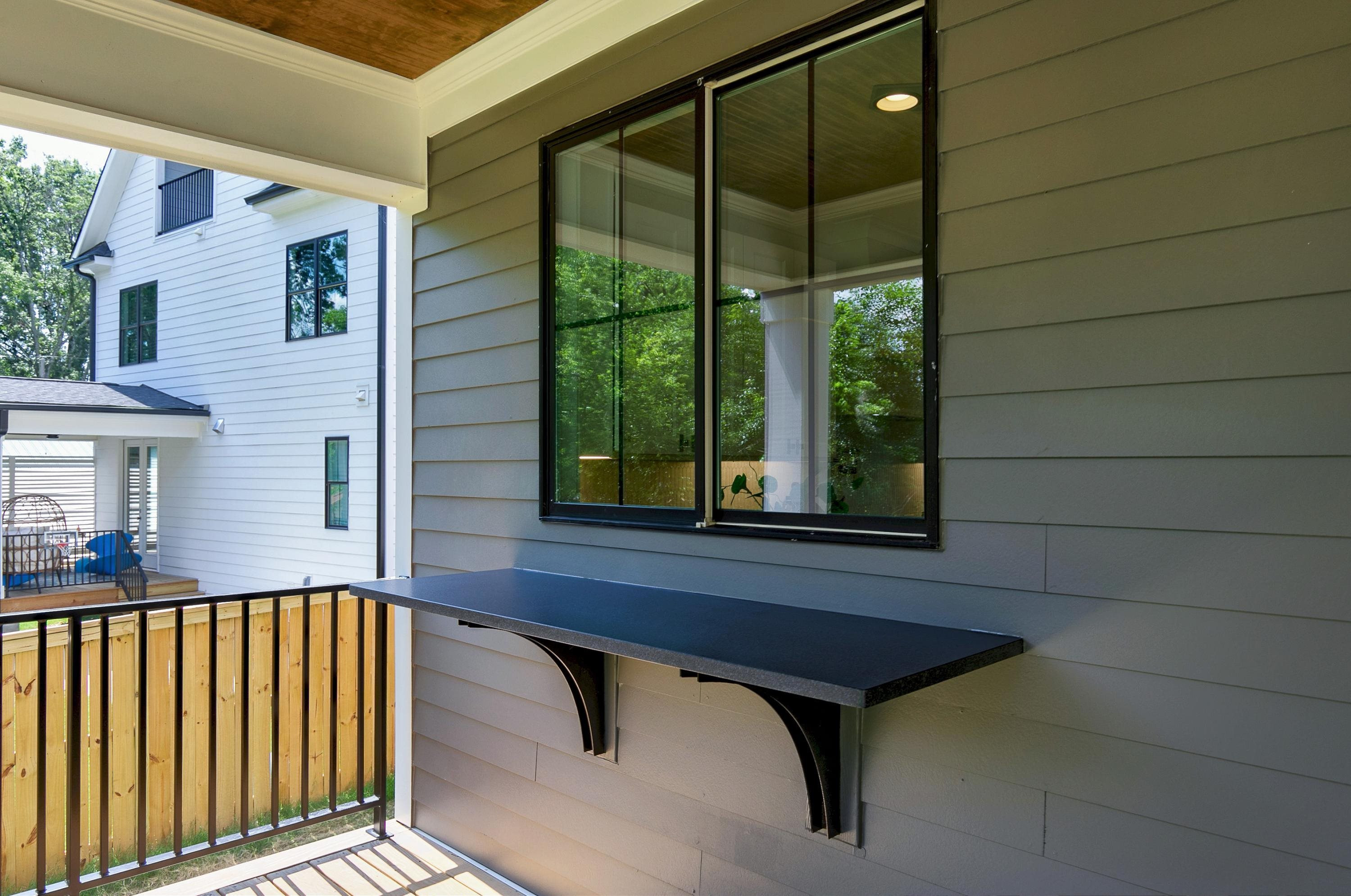 118 Summit Avenue Raleigh, NC 27603 - Photo 29 of 30 a view of a balcony with chairs and wooden floor
