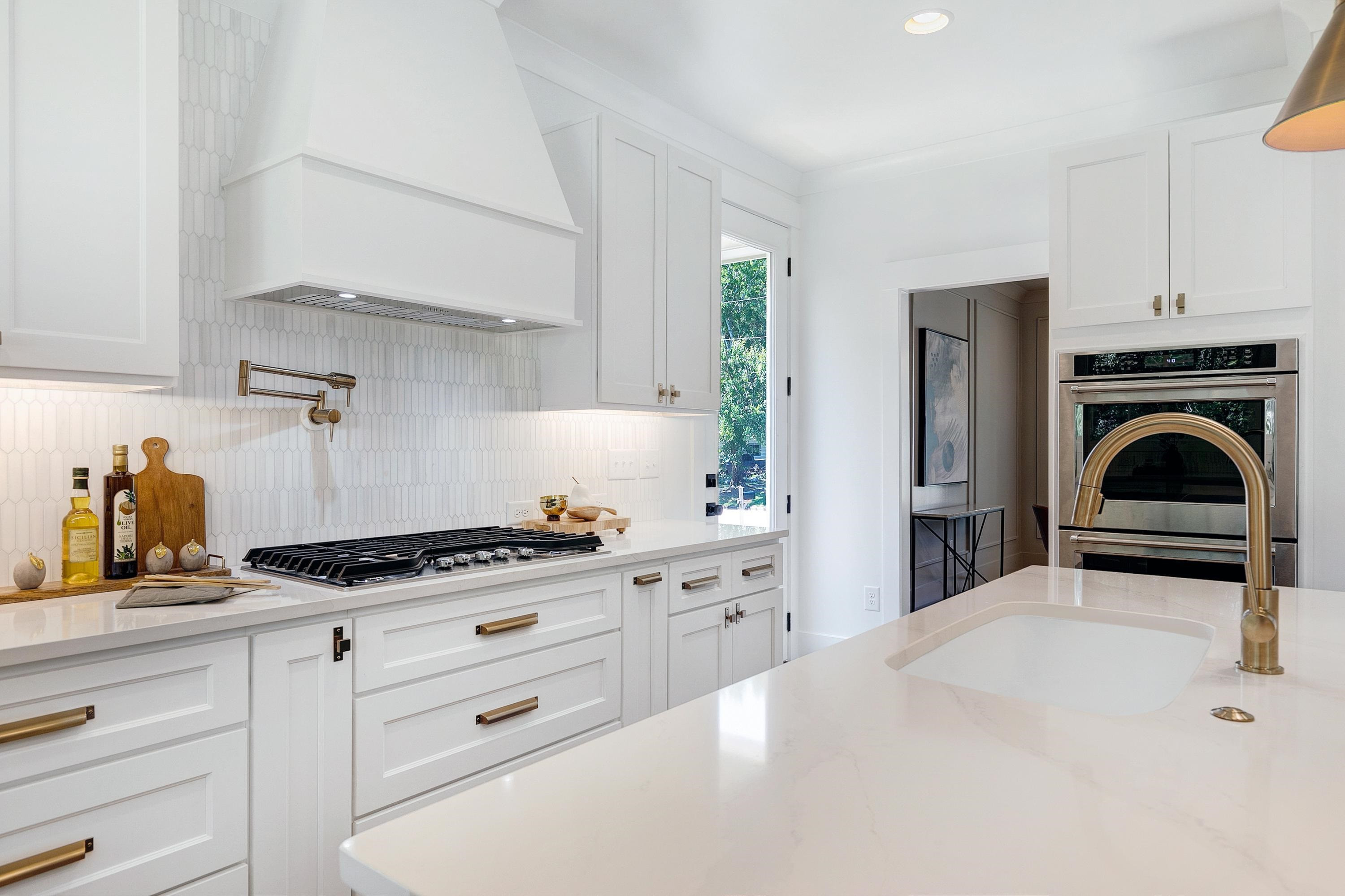118 Summit Avenue Raleigh, NC 27603 - Photo 10 of 30 a kitchen with granite countertop a stove a sink and a white cabinets