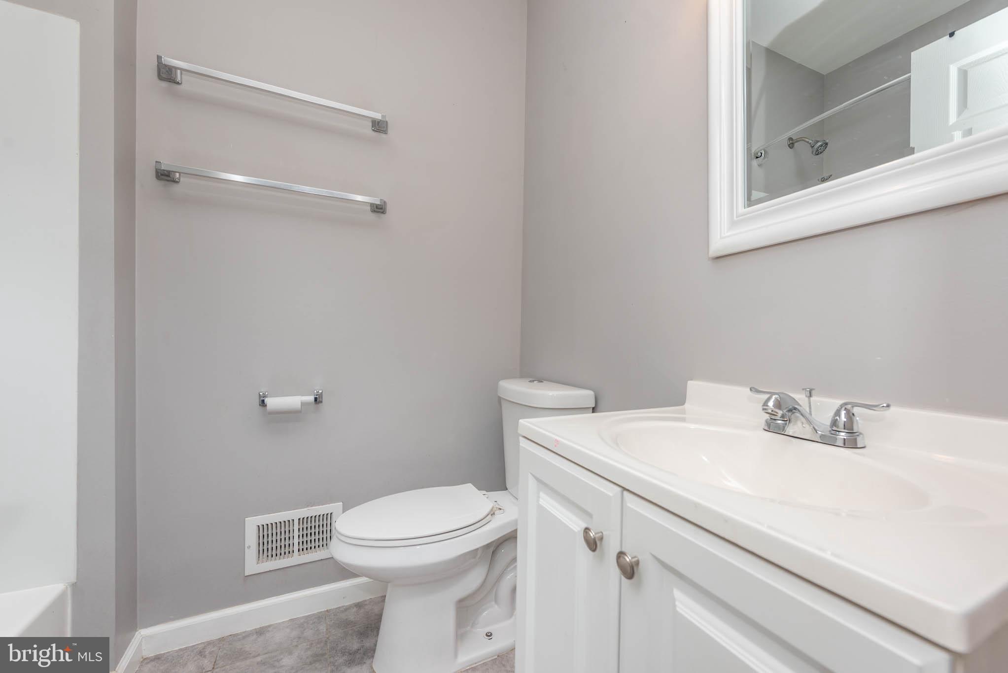 2118 East Hoffman Street Baltimore, MD 21213 - Photo 11 of 19 a bathroom with a sink mirror and toilet