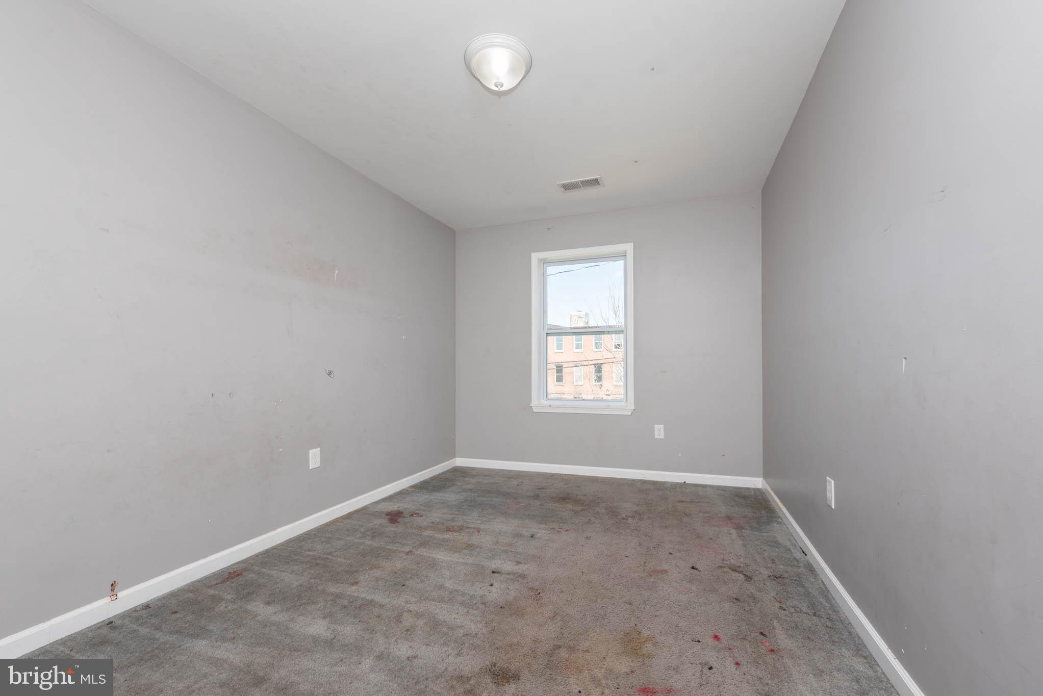 2118 East Hoffman Street Baltimore, MD 21213 - Photo 15 of 19 an empty room with a window