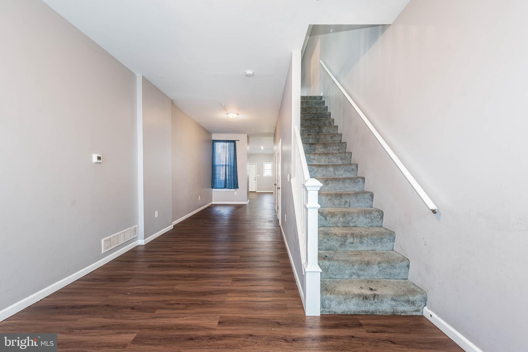 2118 East Hoffman Street Baltimore, MD 21213 - Photo 2 of 19 a view of entryway and hall with wooden floor