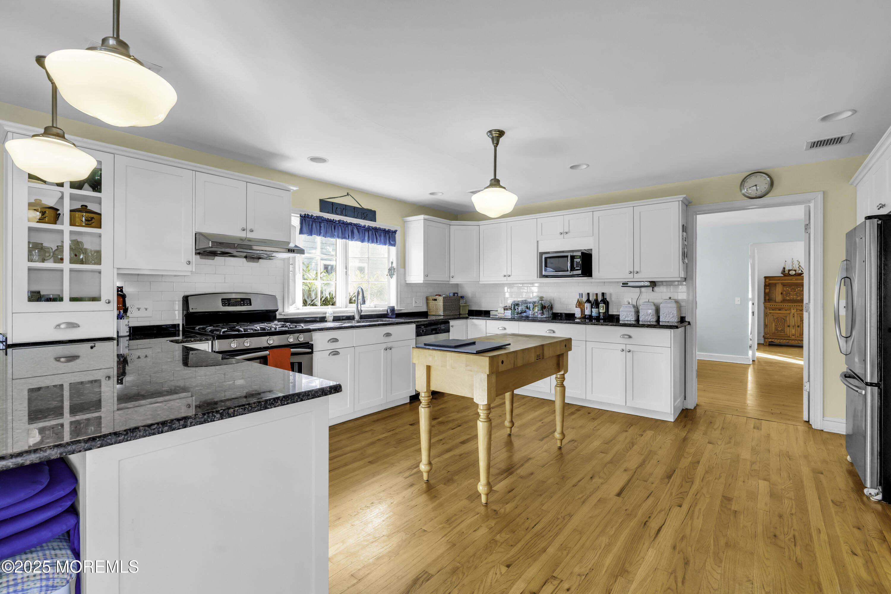 326 South Boulevard Spring Lake, NJ 07762 - Photo 15 of 54 a kitchen with stainless steel appliances granite countertop a stove top oven a sink dishwasher a dining table and chairs with wooden floor