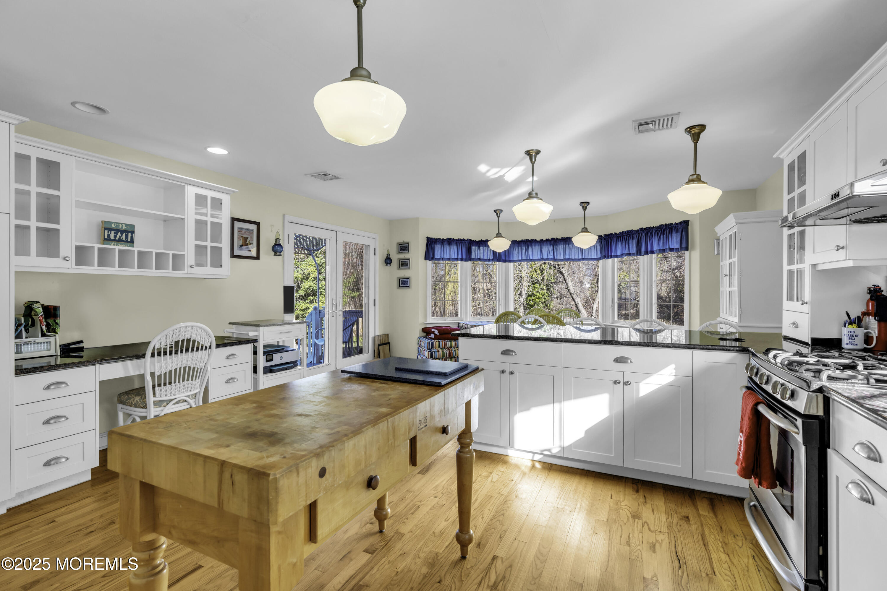 326 South Boulevard Spring Lake, NJ 07762 - Photo 17 of 54 a kitchen with stainless steel appliances granite countertop a stove top oven a sink dishwasher and white cabinets with wooden floor