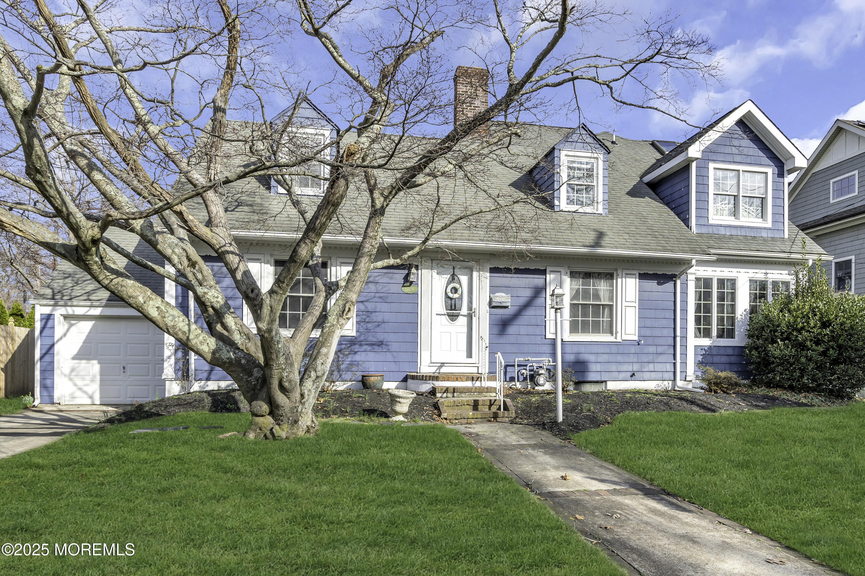 326 South Boulevard Spring Lake, NJ 07762 - Photo 2 of 54 a front view of a house with a garden and trees