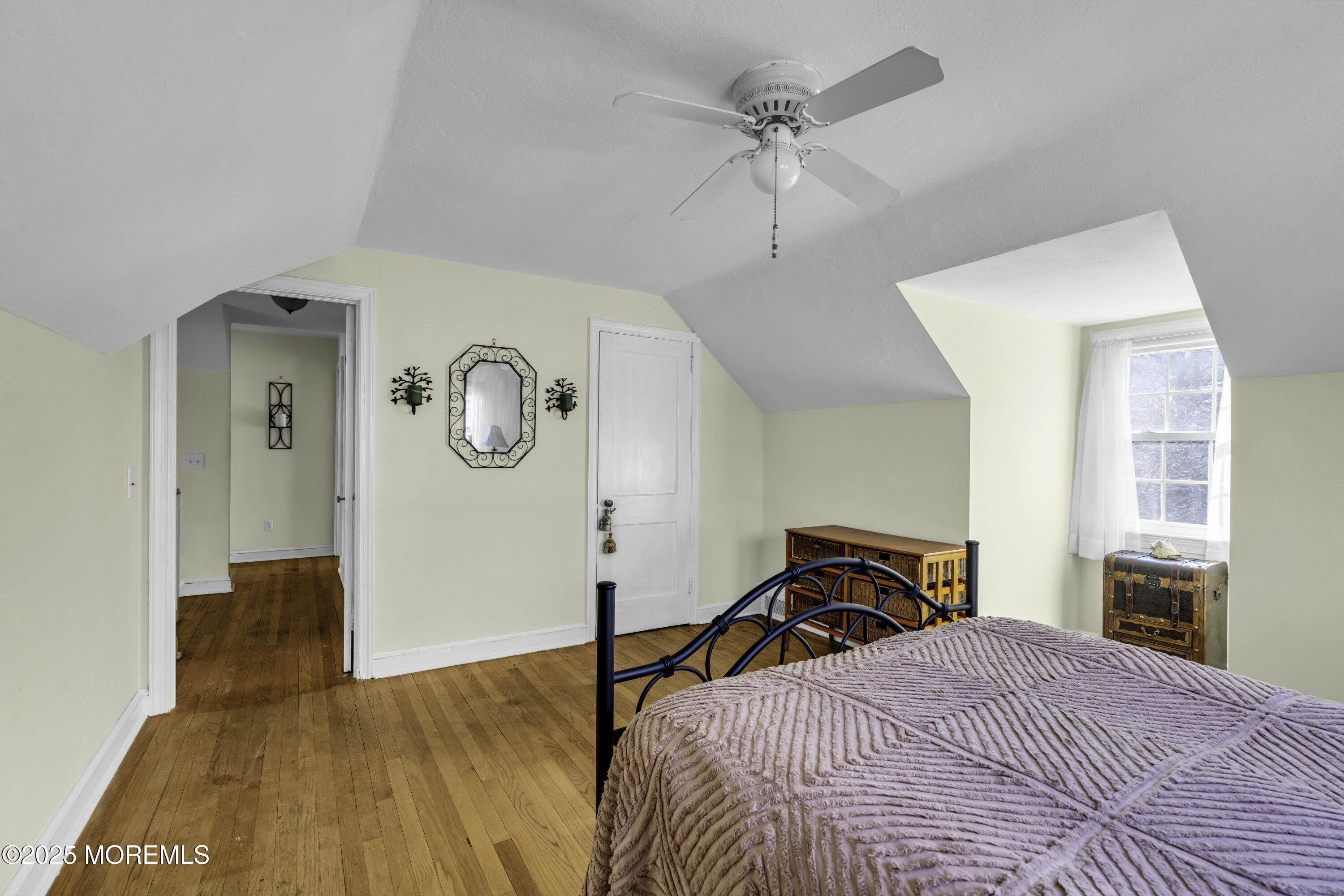 326 South Boulevard Spring Lake, NJ 07762 - Photo 30 of 54 a bedroom with a bed and a chandelier