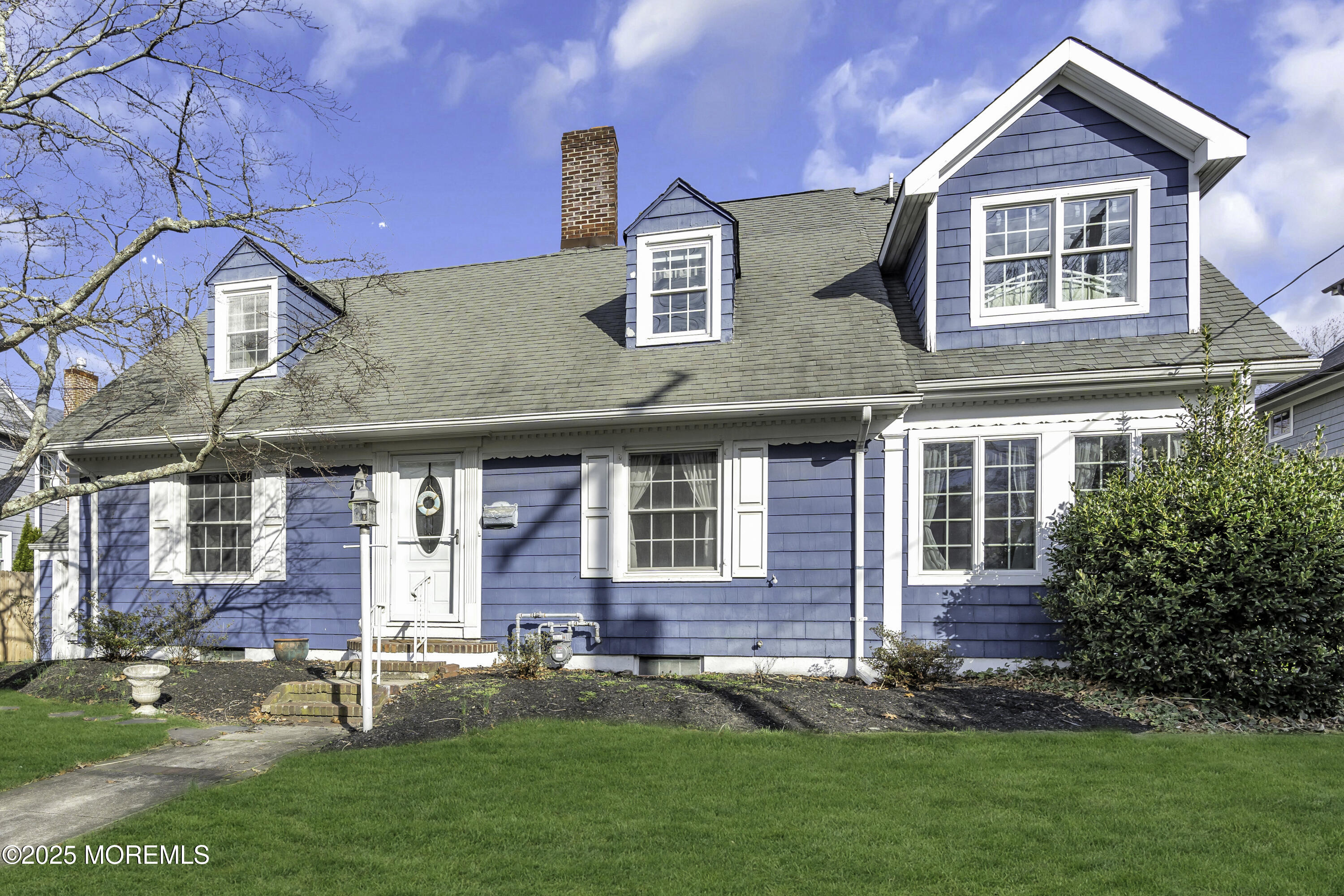 326 South Boulevard Spring Lake, NJ 07762 - Photo 3 of 54 a front view of a house with a yard and garage