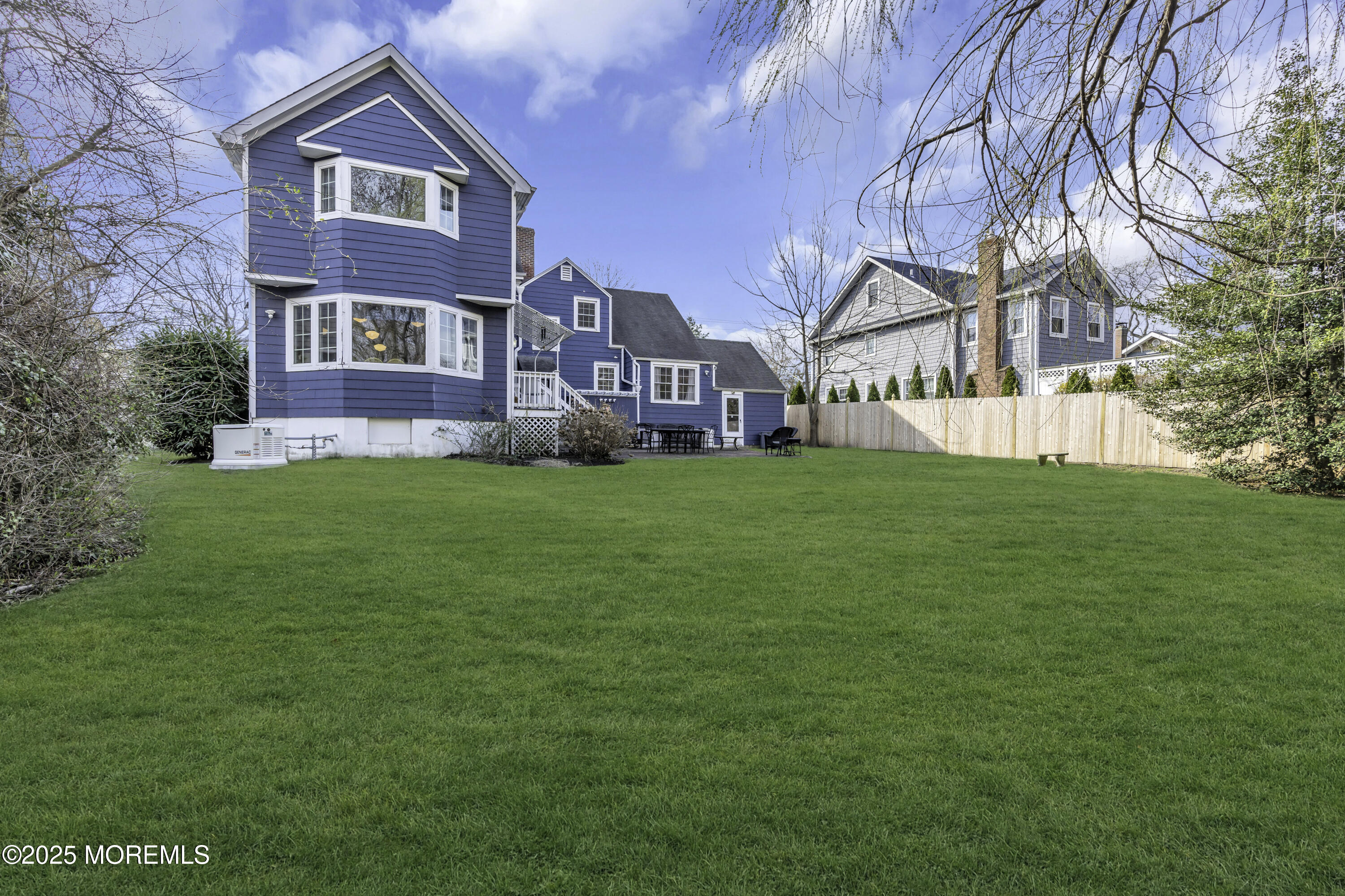 326 South Boulevard Spring Lake, NJ 07762 - Photo 43 of 54 a house that is sitting in the grass with large trees and plants