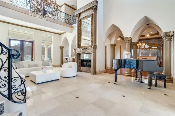 a living room with furniture and a chandelier