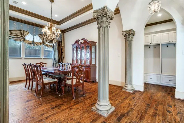 a view of a dining room with furniture wooden floor and chandelier