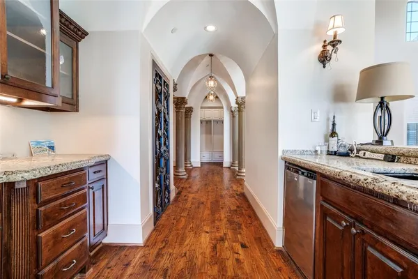 a view of a hallway with entryway wooden floor and front door