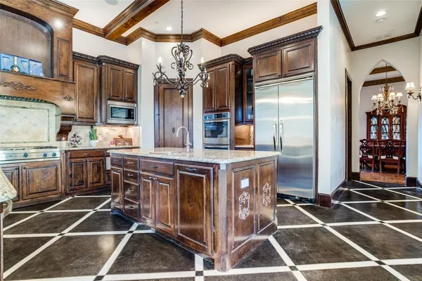 a kitchen with stainless steel appliances a stove a sink and a refrigerator
