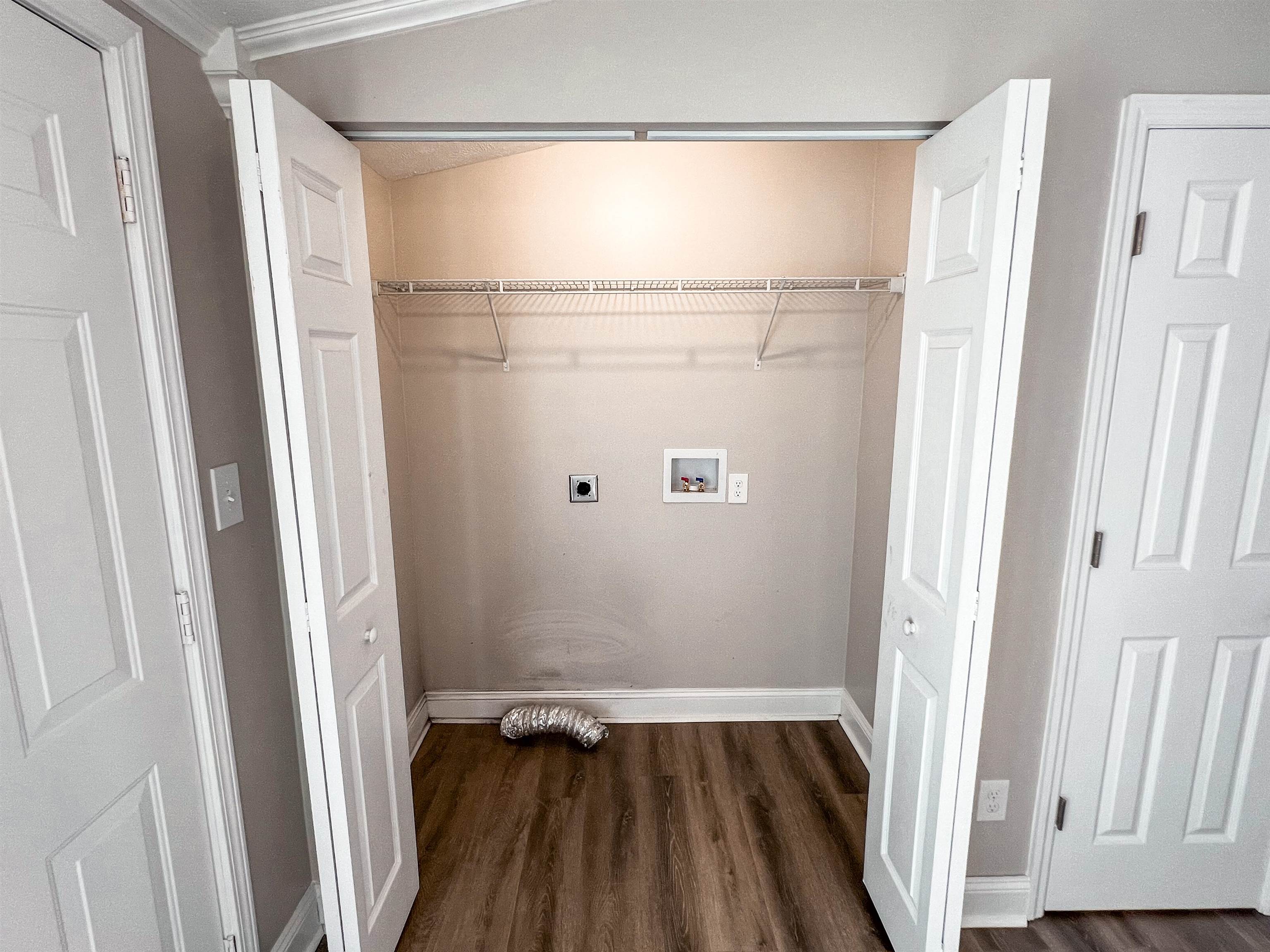 202 Morris Street Waynesboro, TN 38485 - Photo 24 of 36 Laundry area with electric dryer hookup, dark wood-type flooring, and washer hookup