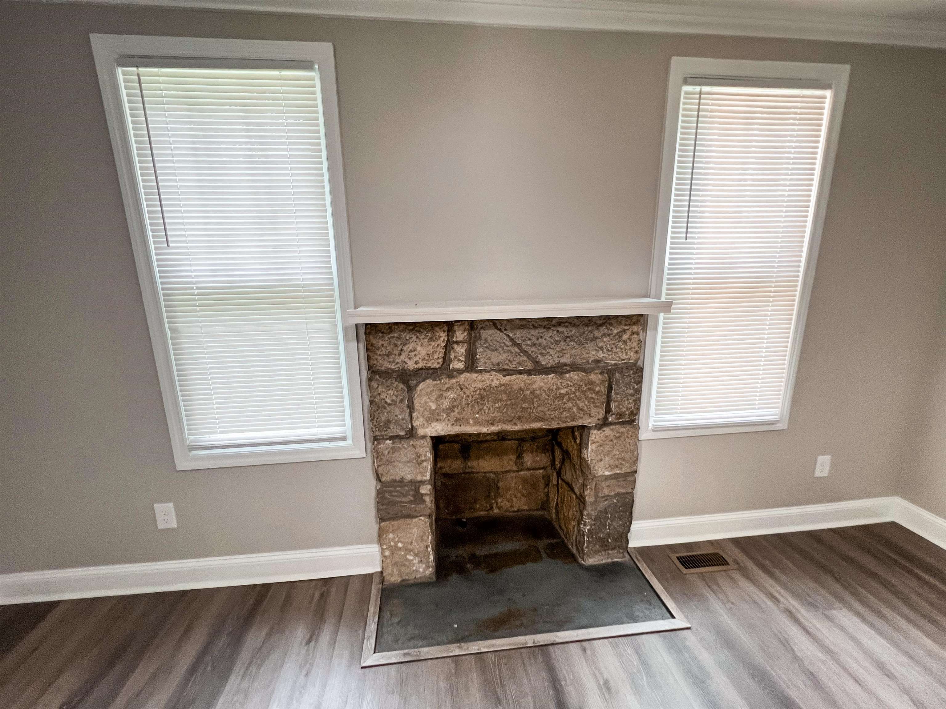 202 Morris Street Waynesboro, TN 38485 - Photo 4 of 36 Unfurnished living room featuring a fireplace, wood finished floors, and crown molding