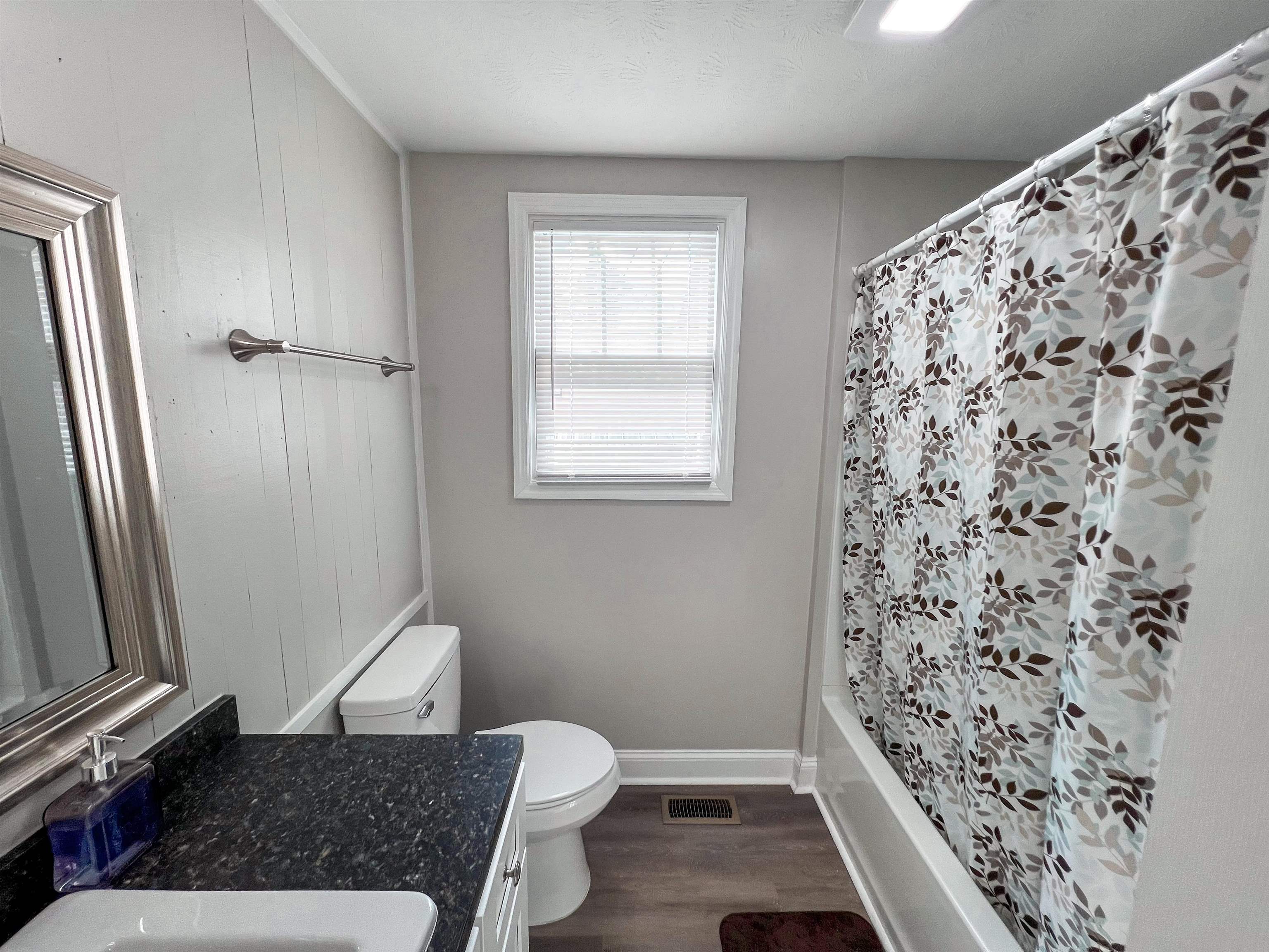 202 Morris Street Waynesboro, TN 38485 - Photo 10 of 36 Bathroom featuring vanity, wood finished floors, and shower / bath combo