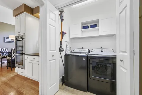 a kitchen with stainless steel appliances granite countertop a refrigerator and a stove