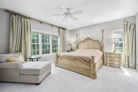 a spacious bedroom with a bed and a large window with outer view