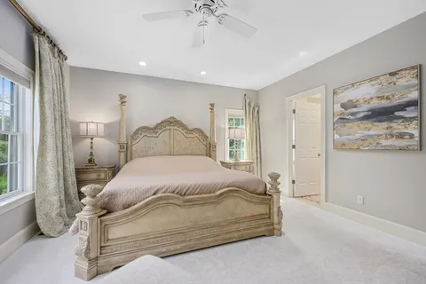 a bedroom with a bed and a painting on the wall