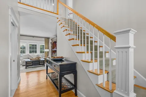 a view of an entryway with wooden floor and windows