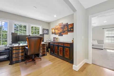 a view of a workspace with furniture and a window