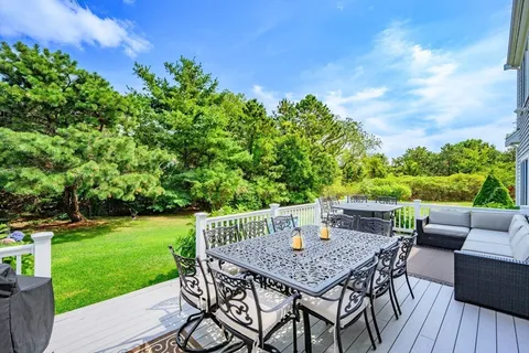 a view of a backyard with furniture and garden