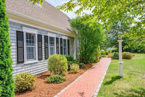 a view of a house with garden and porch