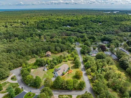 an aerial view of a house with a yard
