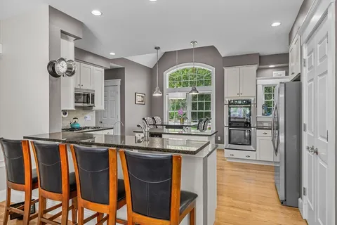 a kitchen with granite countertop a sink and cabinets