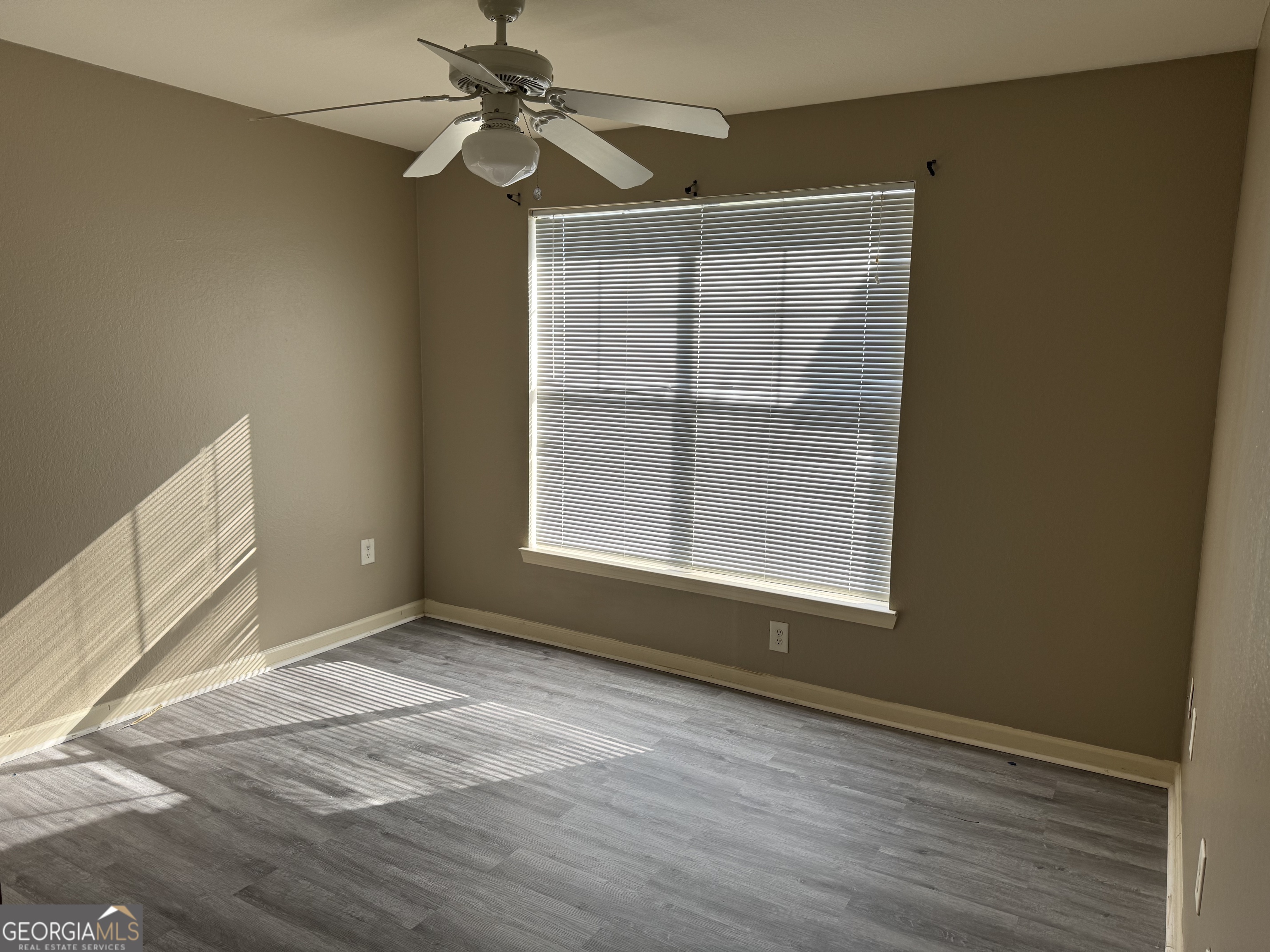 211 North Avenue, Unit 1332 Athens, GA 30601 - Photo 12 of 14 an empty room with wooden floor fan and windows