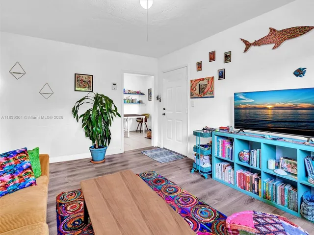 a living room with a couch and a dining table