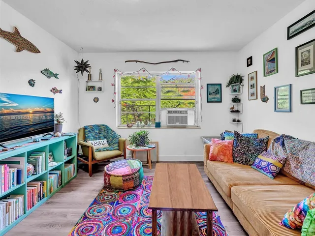 a view of a yard with plants and trees