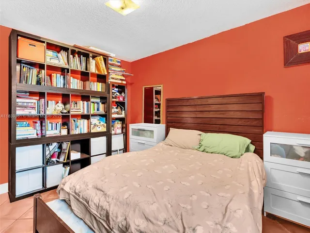 a bedroom with furniture and a large window