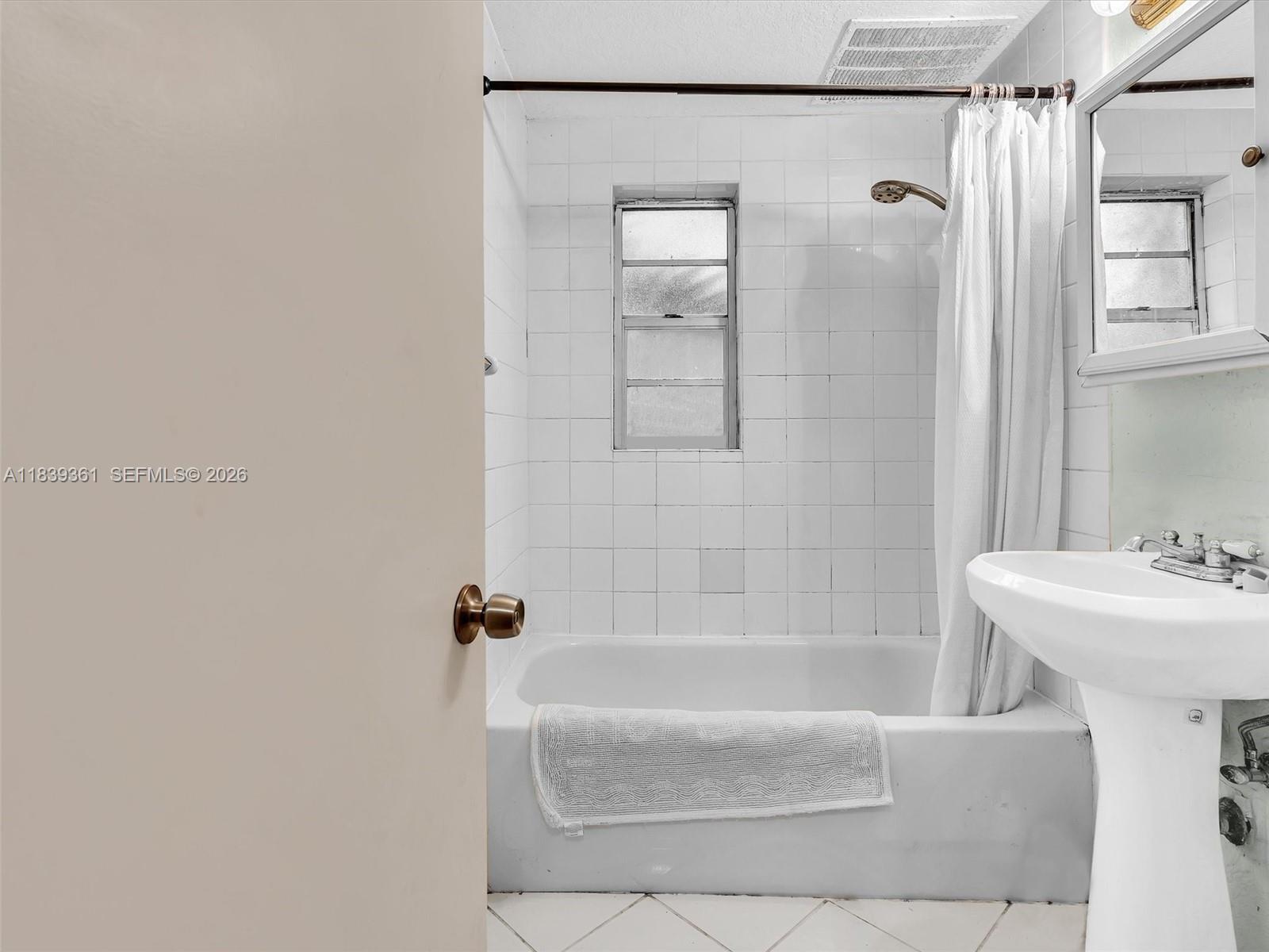 3210 Elizabeth Street Miami, FL 33133 - Photo 46 of 69 a bathroom with a sink a mirror and a bathtub